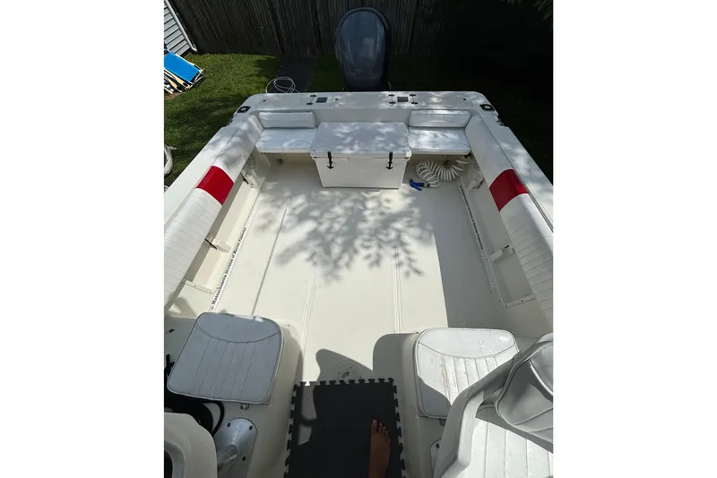 Slide: The Image of 2004 Hydra-Sports Lightning 230 WA boat interior with seating and storage compartments. - 7