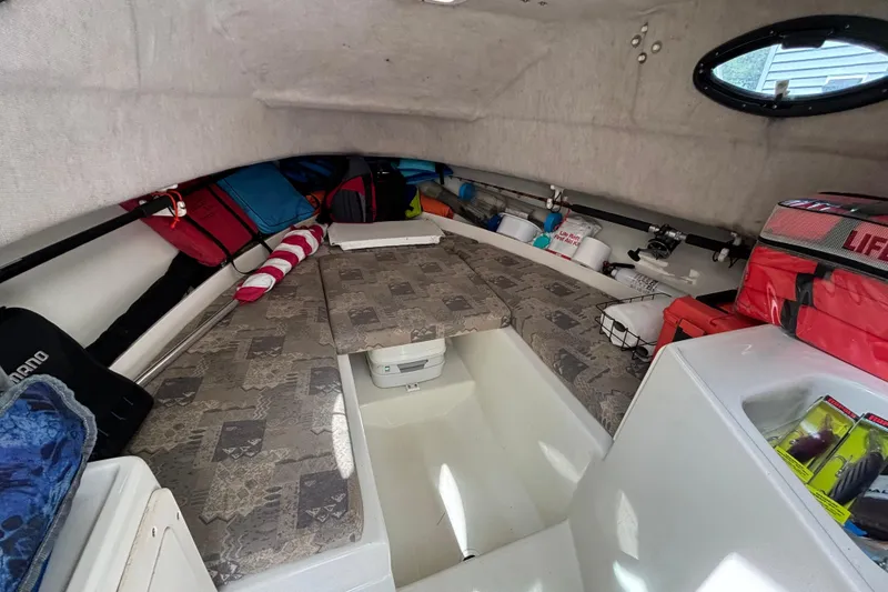 Slide: The Image of 2004 Hydra-Sports Lightning 230 WA cabin interior with storage and seating. - 8