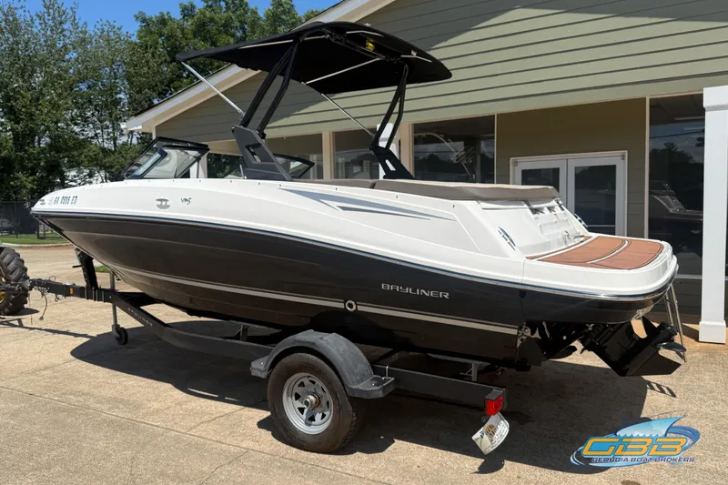 Slide: The Image of 2018 Bayliner VR5 Bowrider I/O on trailer, parked outdoors near a building. - 1