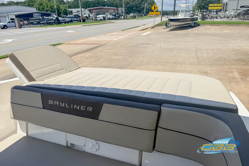 Slide: The Image of 2018 Bayliner VR5 Bowrider I/O boat with beige seating, parked outdoors. - 15