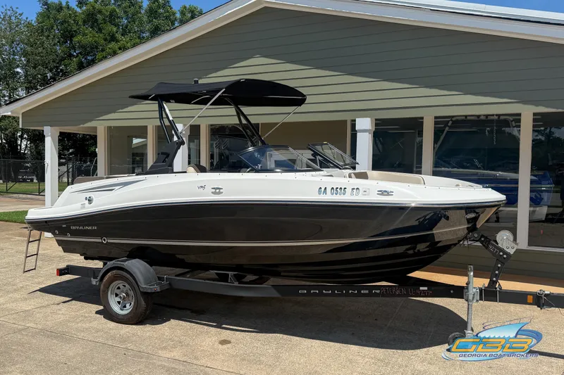 Slide: The Image of 2018 Bayliner VR5 Bowrider I/O boat on trailer, parked outside a building. - 4