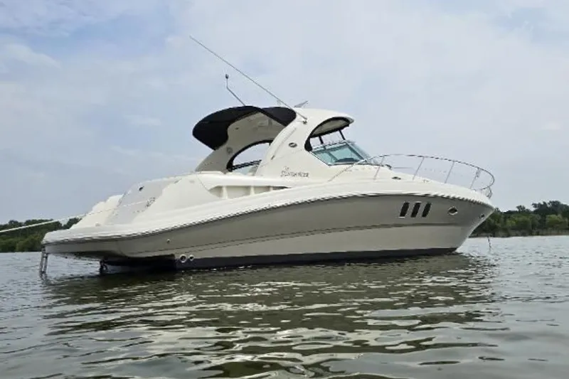 The Image of 2006 Sea Ray 380 Sundancer yacht on calm water under a cloudy sky. - 0
