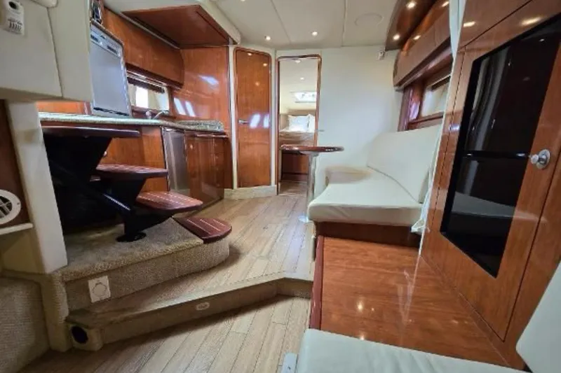 Slide: The Image of Interior of 2006 Sea Ray 380 Sundancer yacht with wood finishes and seating area. - 11