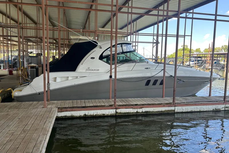 Slide: The Image of 2006 Sea Ray 380 Sundancer docked in a covered marina. - 2