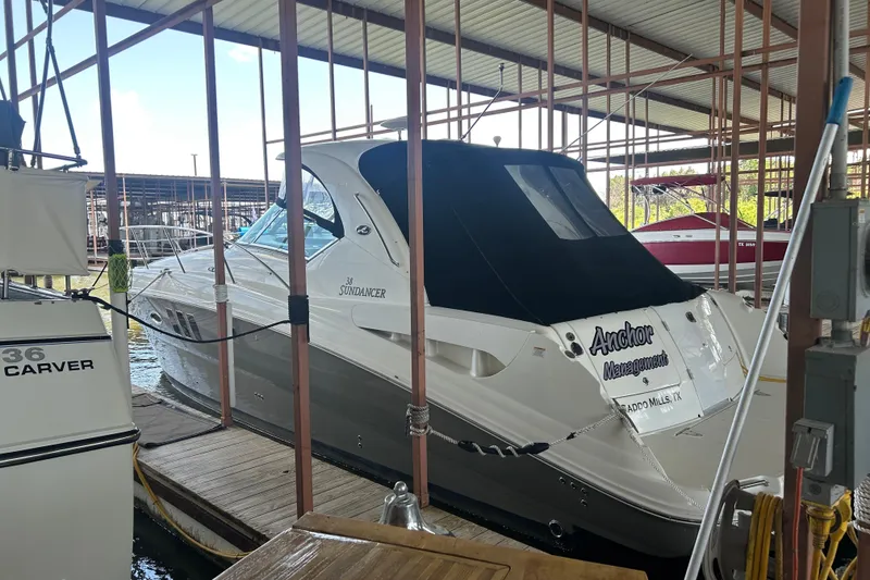 Slide: The Image of 2006 Sea Ray 380 Sundancer docked in a marina, covered and secured. - 22