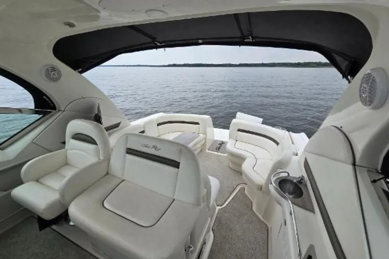 Slide: The Image of 2006 Sea Ray 380 Sundancer boat interior with white seating and lake view. - 3