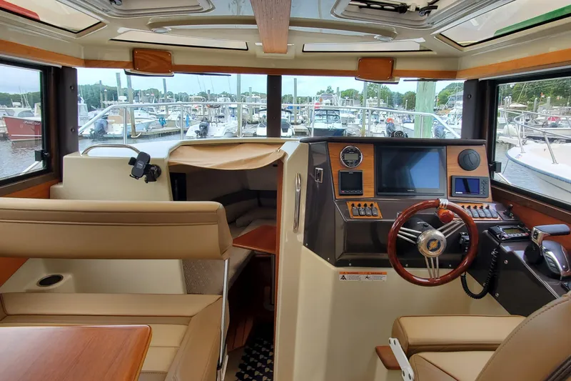 Slide: The Image of Interior of 2021 Ranger Tugs R-25 boat with modern helm and seating. - 16