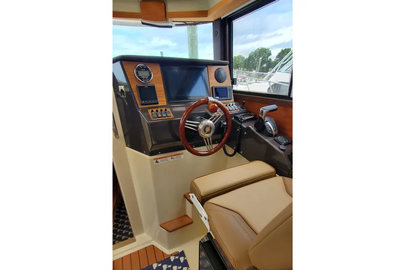 Slide: The Image of Interior helm of 2021 Ranger Tugs R-25 with modern controls and leather seating. - 19