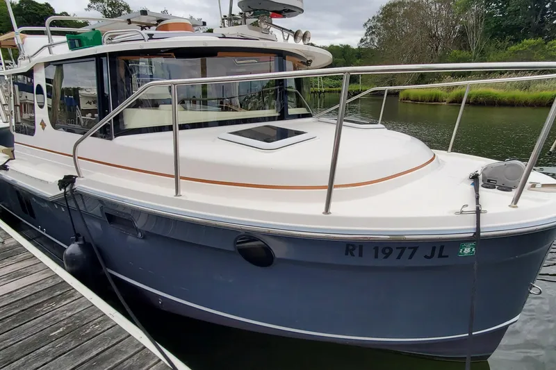 Slide: The Image of 2021 Ranger Tugs R-25 boat docked, featuring sleek design and modern amenities. - 2