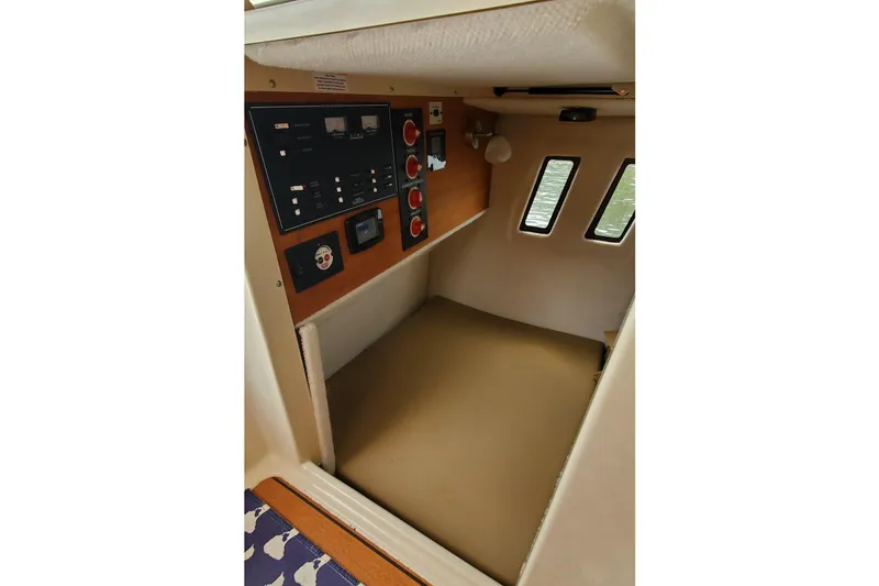 Slide: The Image of Interior cabin of 2021 Ranger Tugs R-25 boat with control panel and windows. - 23