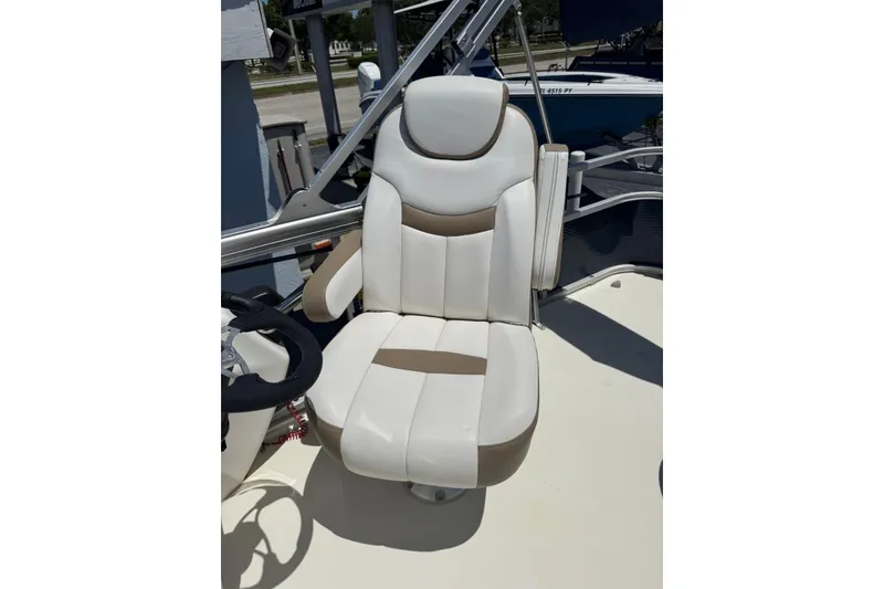 Slide: The Image of Captain's chair on 2013 SouthWind 229 L boat, featuring white and beige upholstery. - 11
