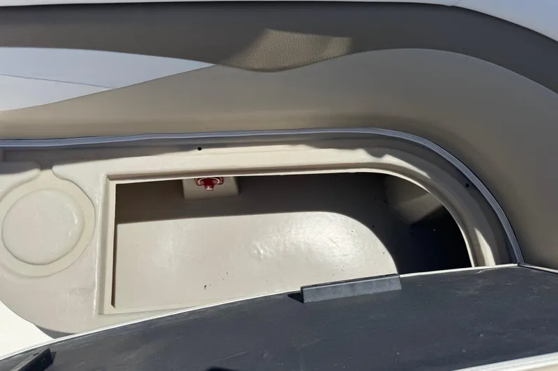 Slide: The Image of Storage compartment in a 2013 SouthWind 229 L boat, featuring a cup holder. - 13