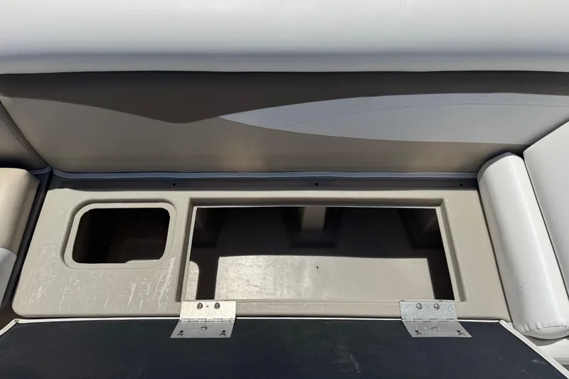 Slide: The Image of Open storage compartment in a 2013 SouthWind 229 L boat, featuring a hinged lid. - 15