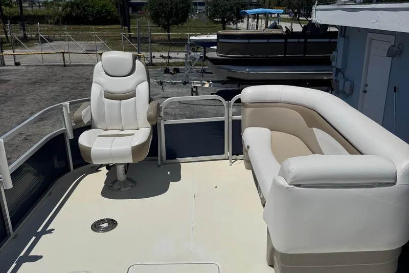 Slide: The Image of 2013 SouthWind 229 L boat interior with white seating and captain's chair. - 16