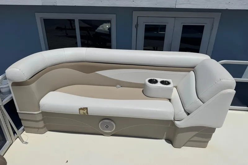 Slide: The Image of 2013 SouthWind 229 L boat seating with cup holders, beige and white upholstery. - 18