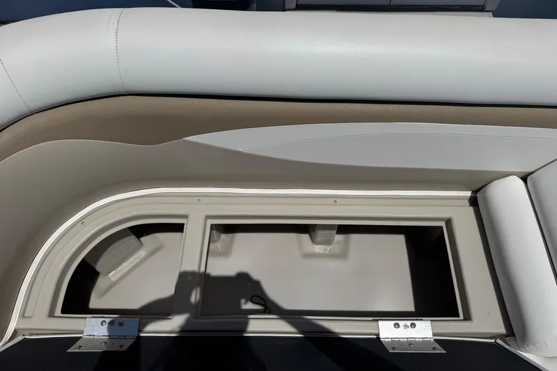 Slide: The Image of 2013 SouthWind 229 L boat storage compartment with cushioned seating and shadow. - 19