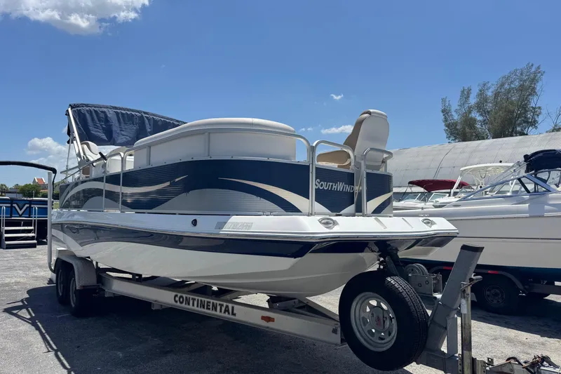 Slide: The Image of 2013 SouthWind 229 L boat on trailer under clear blue sky. - 2