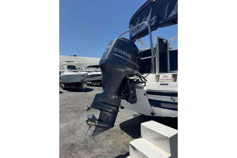 Slide: The Image of 2013 SouthWind 229 L boat with Yamaha outboard motor in a marina setting. - 25