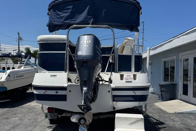 Slide: The Image of 2013 SouthWind 229 L boat with Yamaha 150 outboard motor, parked outdoors. - 3