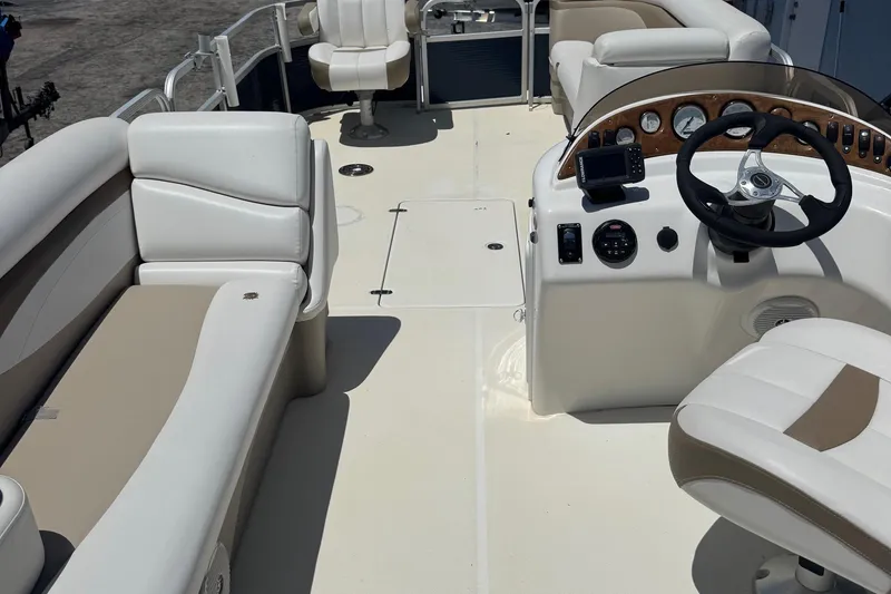 Slide: The Image of 2013 SouthWind 229 L boat interior with white seating and steering console. - 4