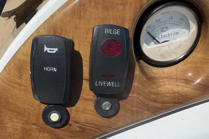 Slide: The Image of 2013 SouthWind 229 L boat dashboard with horn, bilge switches, and voltmeter. - 8
