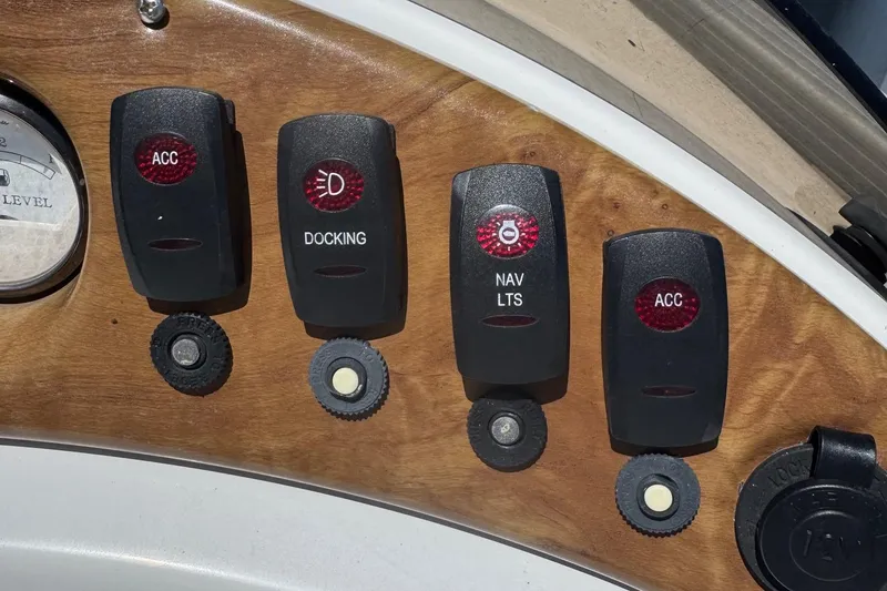 Slide: The Image of Dashboard switches of a 2013 SouthWind 229 L boat, featuring ACC, docking, and navigation lights. - 9
