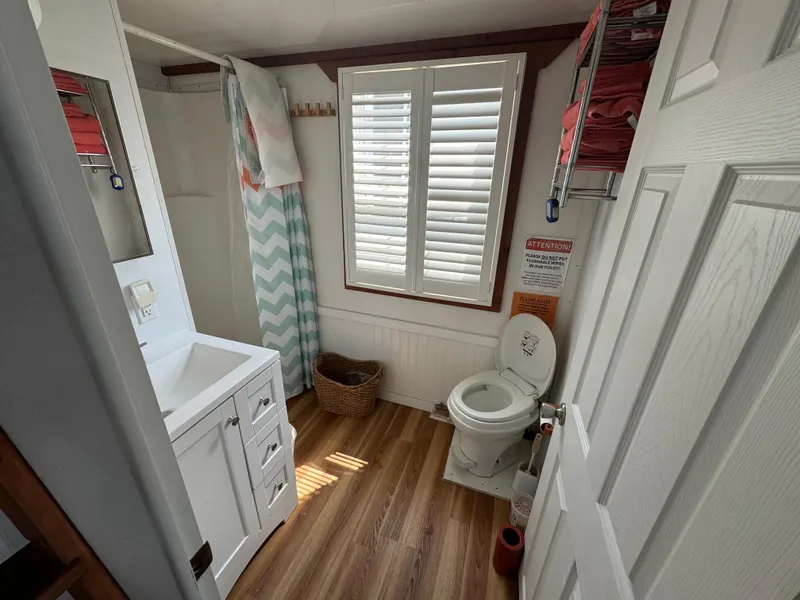 Slide: The Image of Bathroom interior of 2009 Catamaran Cruisers Aqua Lodge with wood flooring and white fixtures. - 12