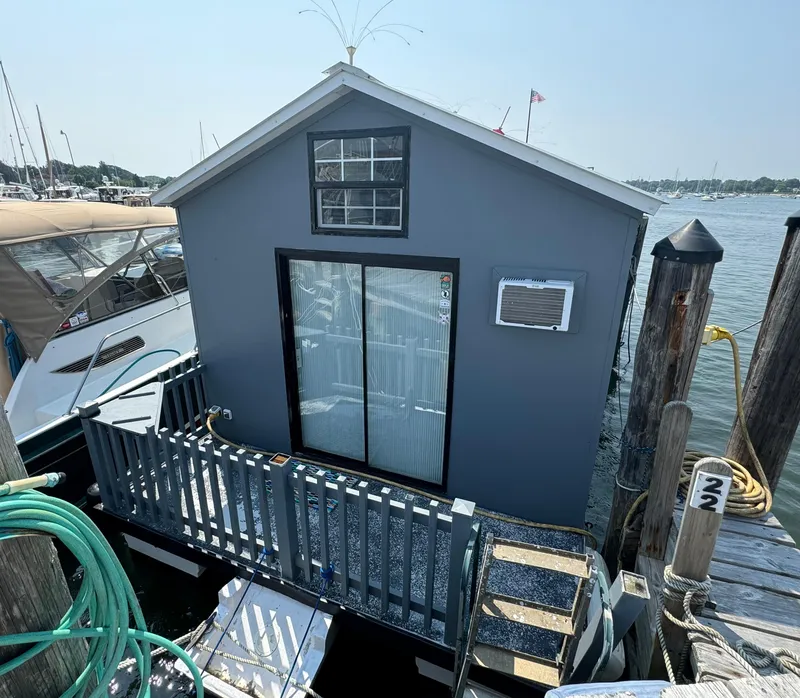 Slide: The Image of 2009 Catamaran Cruisers Aqua Lodge houseboat docked at marina with blue exterior. - 4