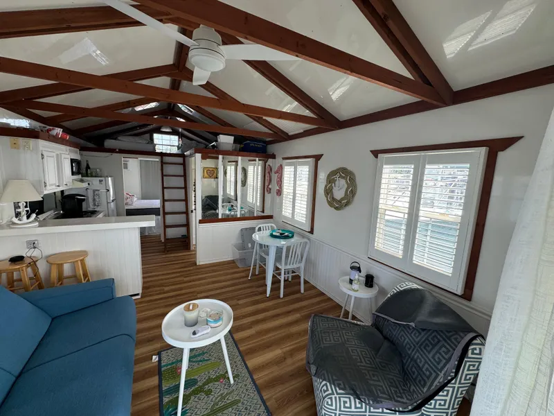 Slide: The Image of Interior of 2009 Catamaran Cruisers Aqua Lodge with cozy seating and kitchen area. - 6