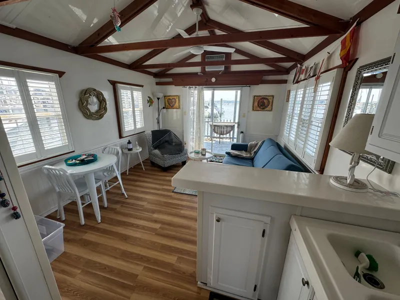 Slide: The Image of Interior of 2009 Catamaran Cruisers Aqua Lodge with cozy seating and dining area. - 9