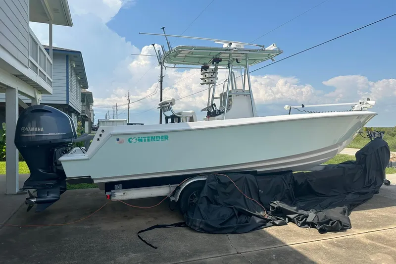 Slide: The Image of 2013 Contender 25 Tournament boat with Yamaha engine parked outdoors. - 11