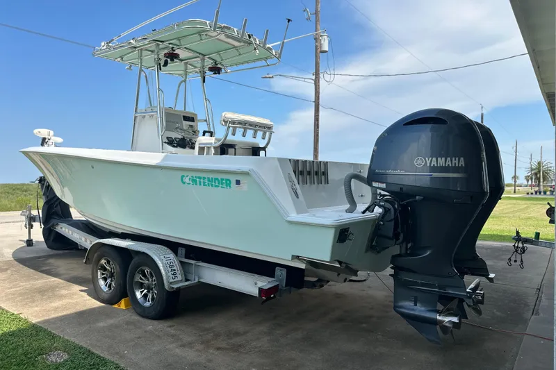 Slide: The Image of 2013 Contender 25 Tournament boat on trailer with Yamaha outboard motor. - 13