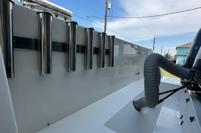 Slide: The Image of 2013 Contender 25 Tournament boat with rod holders and engine hose detail. - 16