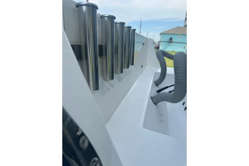 Slide: The Image of 2013 Contender 25 Tournament boat with stainless steel rod holders and hoses. - 17