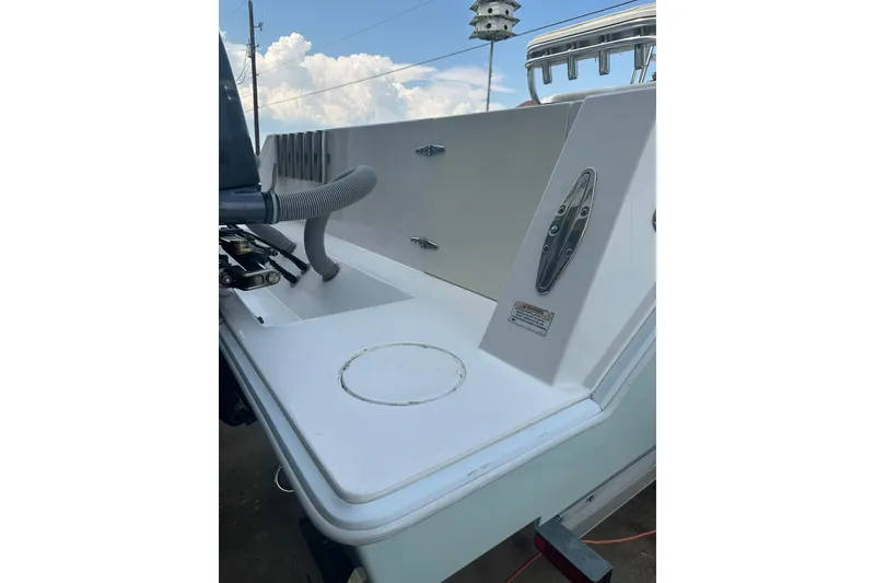 Slide: The Image of 2013 Contender 25 Tournament boat deck with rod holders and cleat, under a cloudy sky. - 18