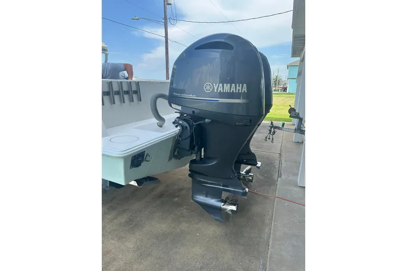 Slide: The Image of 2013 Contender 25 Tournament boat with Yamaha outboard motor, parked on concrete. - 19