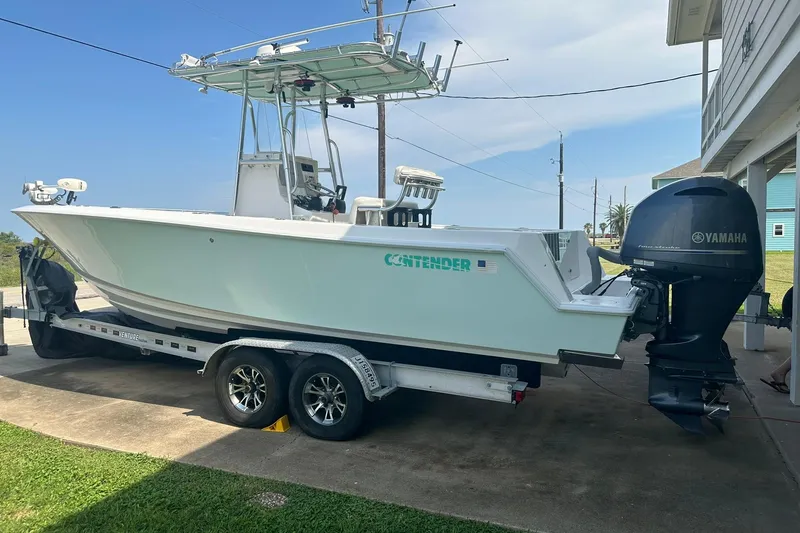 Slide: The Image of 2013 Contender 25 Tournament boat on trailer with Yamaha outboard motor. - 2