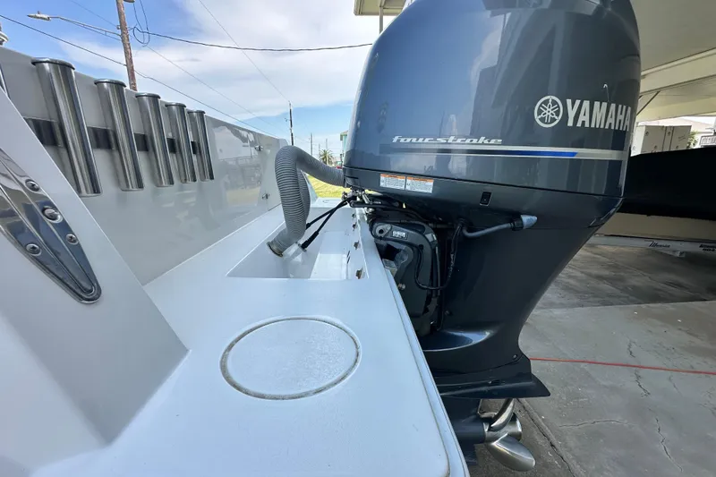 Slide: The Image of 2013 Contender 25 Tournament boat with Yamaha four-stroke engine, docked outdoors. - 22