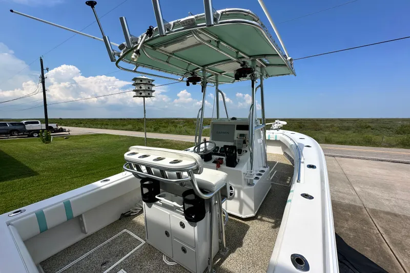Slide: The Image of 2013 Contender 25 Tournament boat with T-top and Garmin electronics, parked on a driveway. - 26