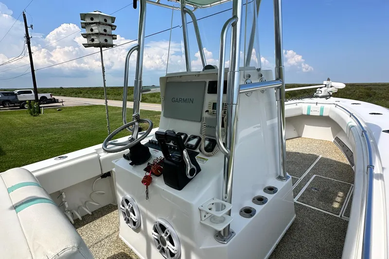 Slide: The Image of 2013 Contender 25 Tournament boat with Garmin navigation, parked on grass under blue sky. - 28