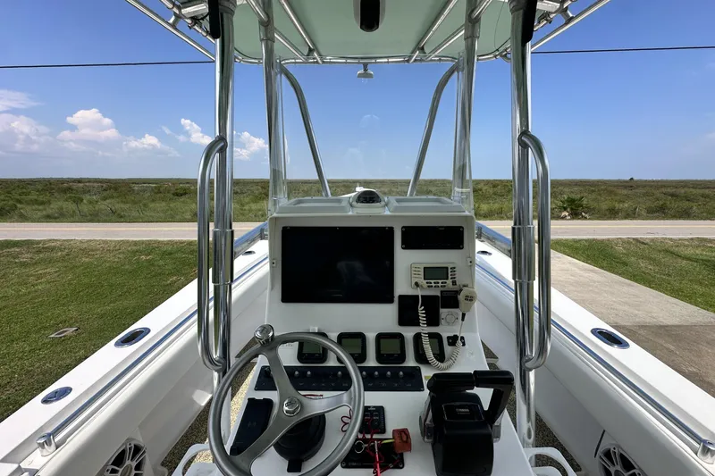 Slide: The Image of 2013 Contender 25 Tournament boat dashboard with steering wheel and navigation equipment. - 29