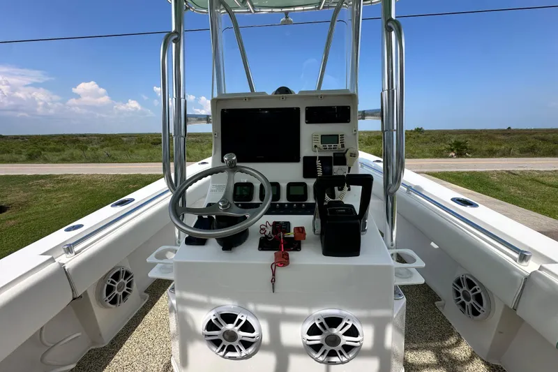 Slide: The Image of 2013 Contender 25 Tournament boat console with steering wheel and navigation equipment. - 30