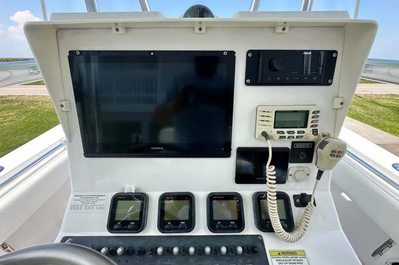 Slide: The Image of Control panel of a 2013 Contender 25 Tournament boat with navigation and communication equipment. - 31