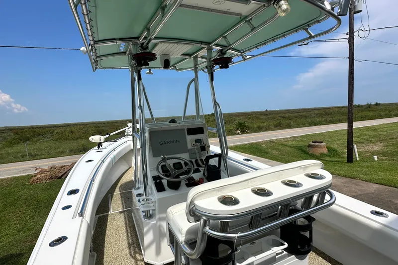 Slide: The Image of 2013 Contender 25 Tournament boat with Garmin system, parked on grass near a road. - 32