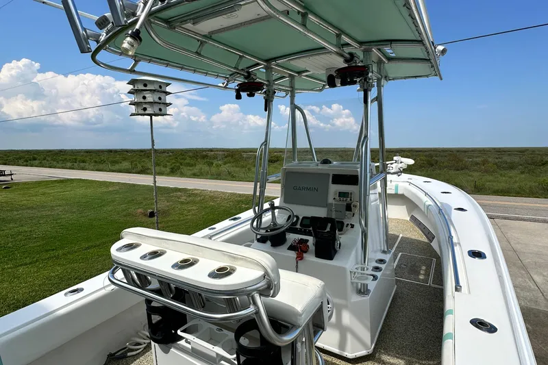 Slide: The Image of 2013 Contender 25 Tournament boat with Garmin system, parked on grass under blue sky. - 35