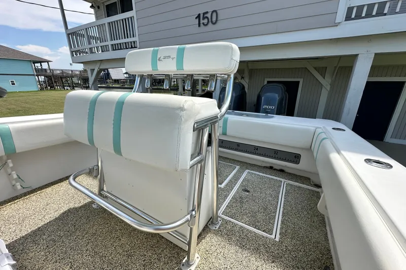 Slide: The Image of 2013 Contender 25 Tournament boat interior with seating and dual engines. - 36