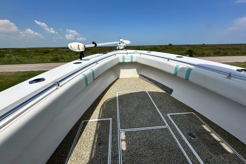 Slide: The Image of 2013 Contender 25 Tournament boat deck with white and teal accents, clear sky background. - 43
