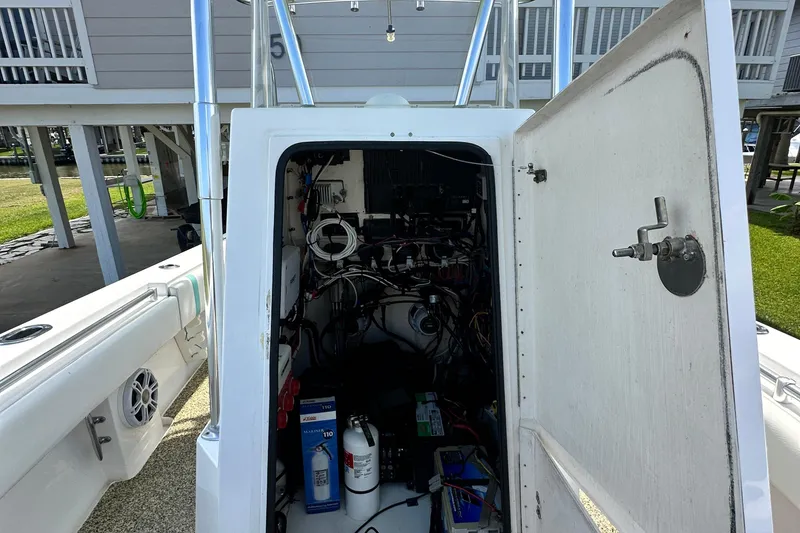 Slide: The Image of 2013 Contender 25 Tournament boat interior showing wiring and equipment storage. - 46