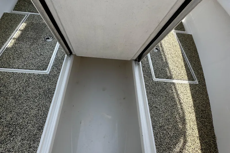 Slide: The Image of 2013 Contender 25 Tournament boat interior with storage compartments and textured flooring. - 49
