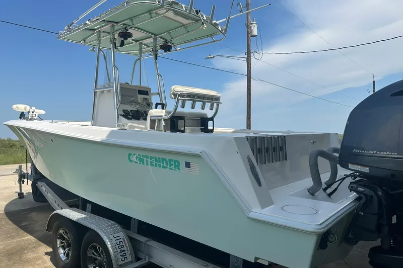 Slide: The Image of 2013 Contender 25 Tournament boat on trailer, featuring center console and outboard motor. - 5